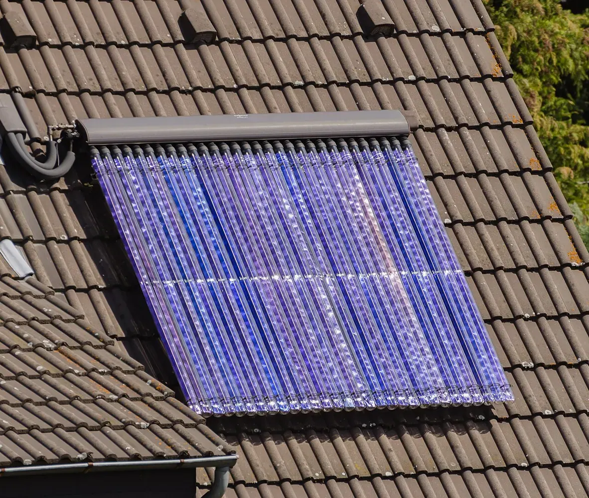 A solar thermal collector mounted on a tiled roof.