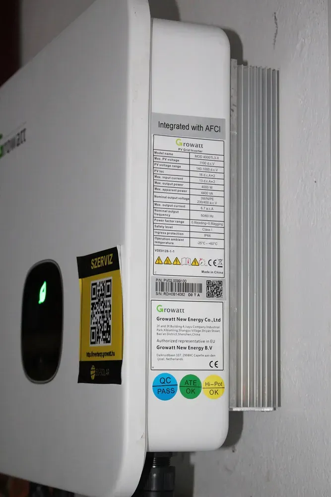 A wall-mounted photovoltaic inverter and its connections.