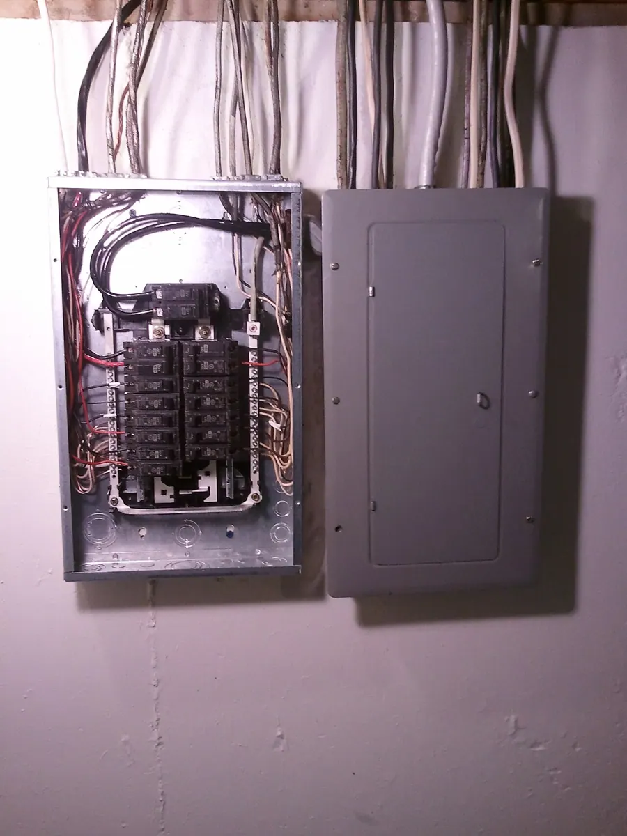 Household electrical distribution panels with circuit breakers and labeled circuits.