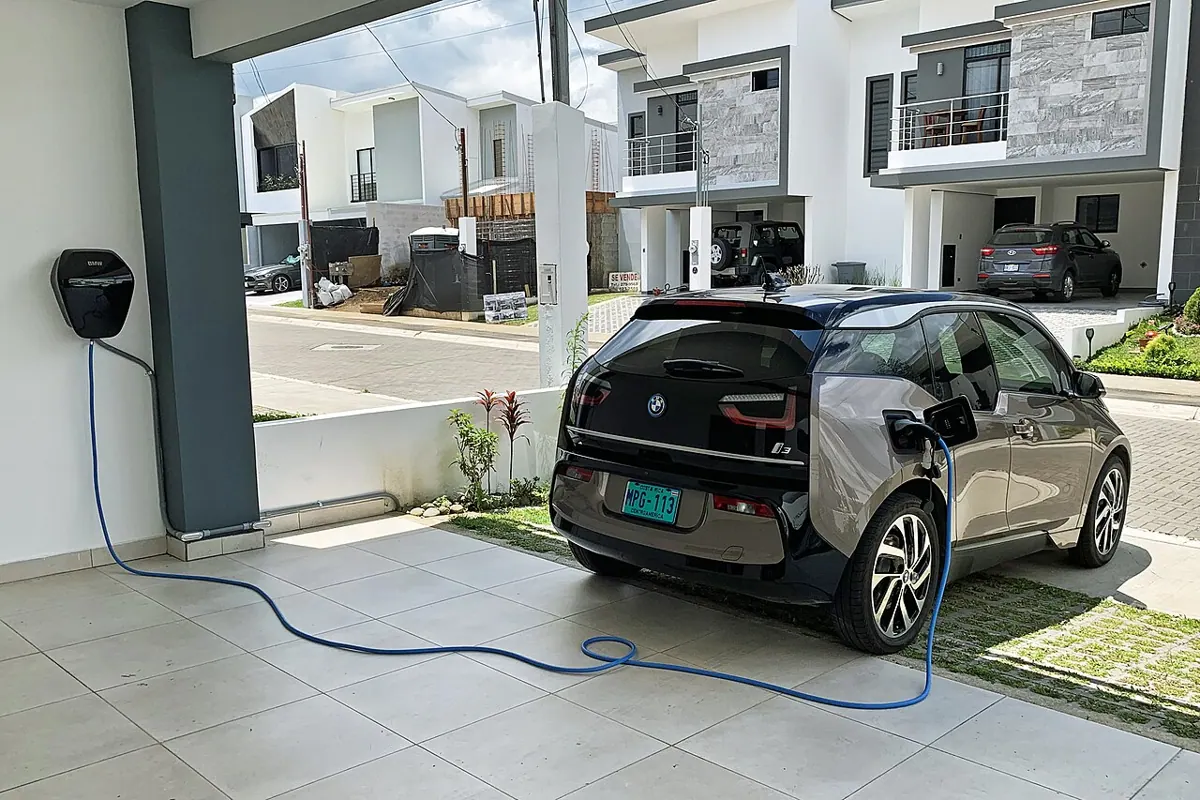 A BMW i3 connected to a home charging cable.