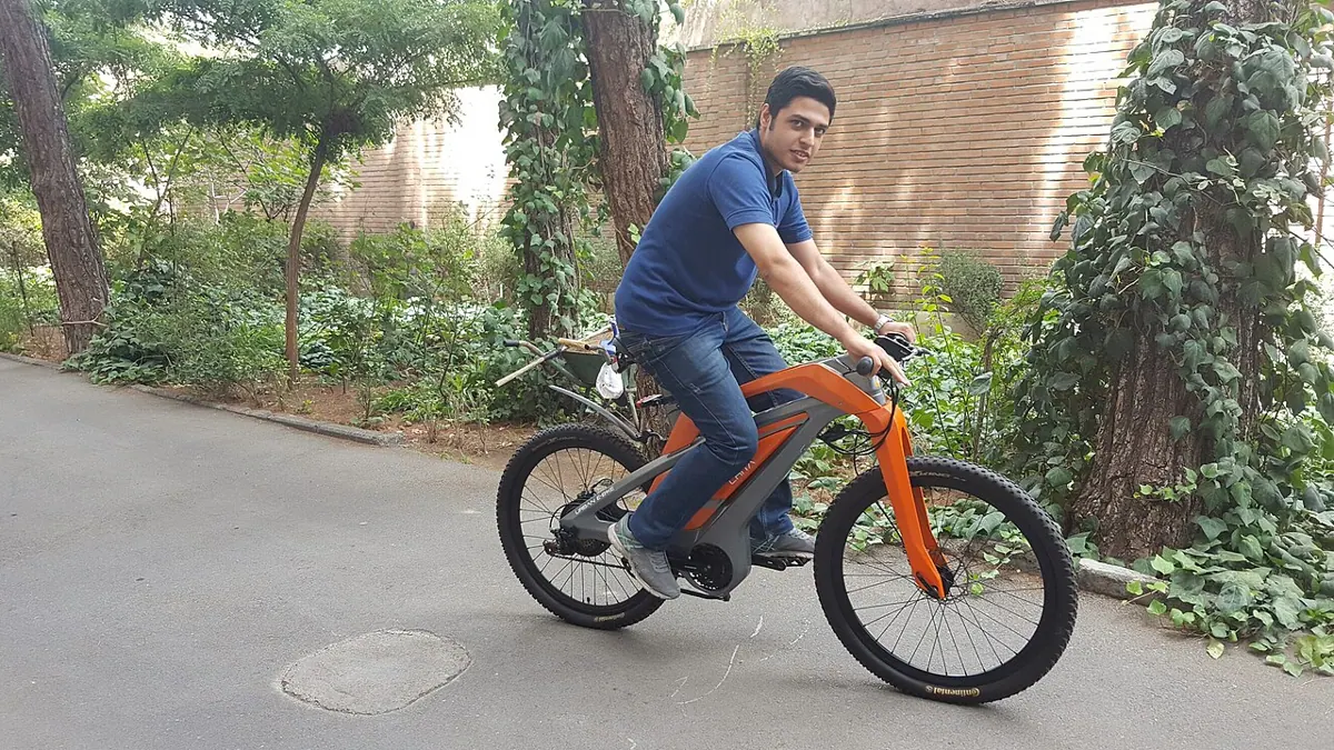 A person riding an electric bicycle outdoors.