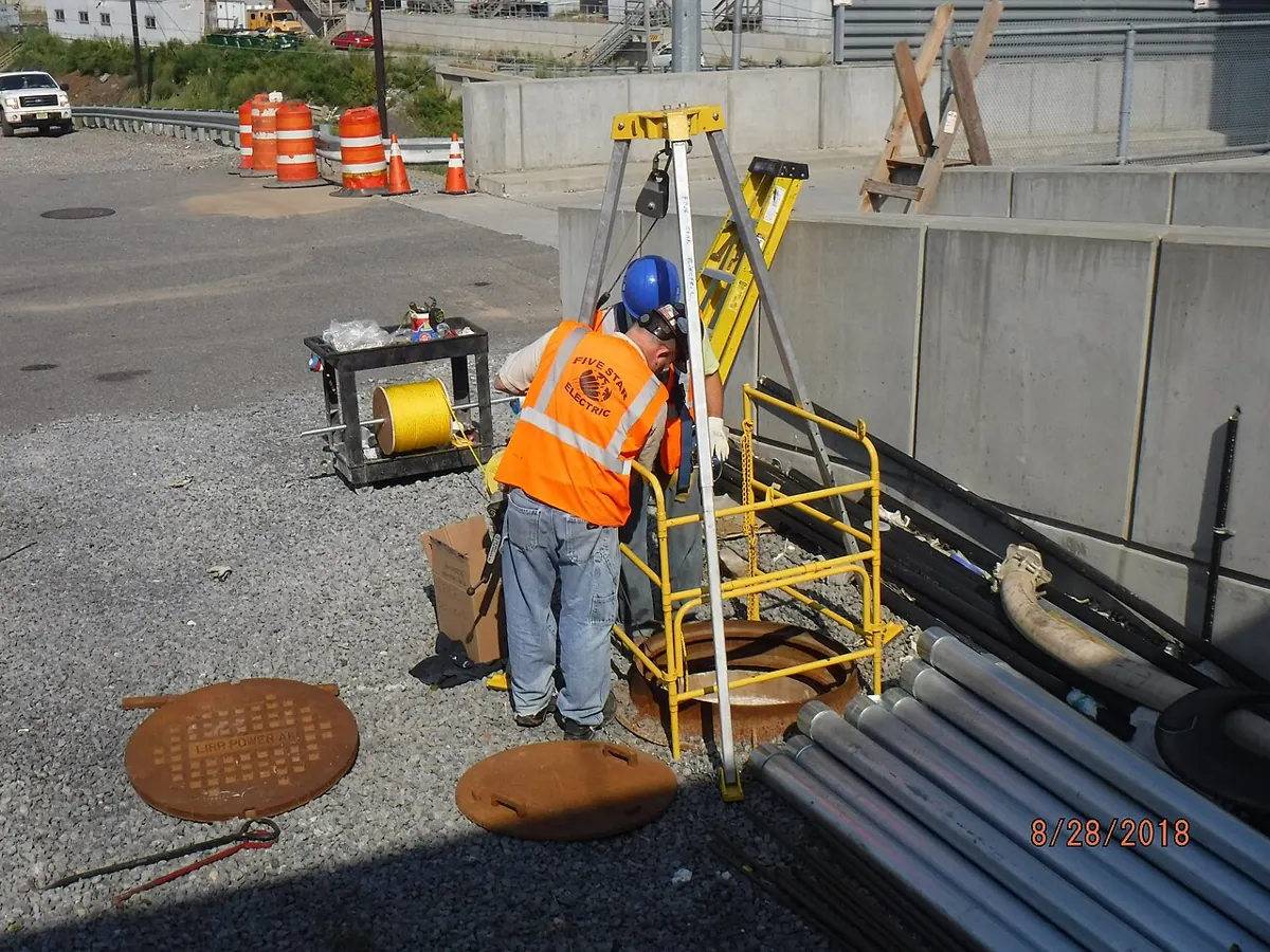 Installation of high-voltage feeder cables at a power substation in Queens.