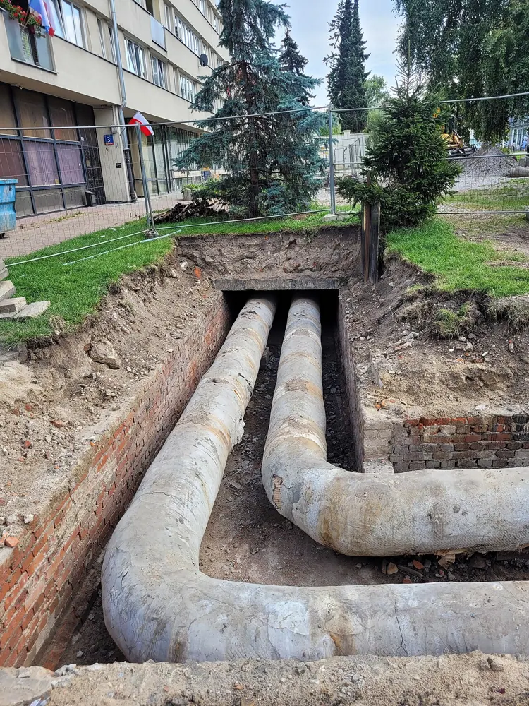 Large district heating pipes exposed during street repairs.