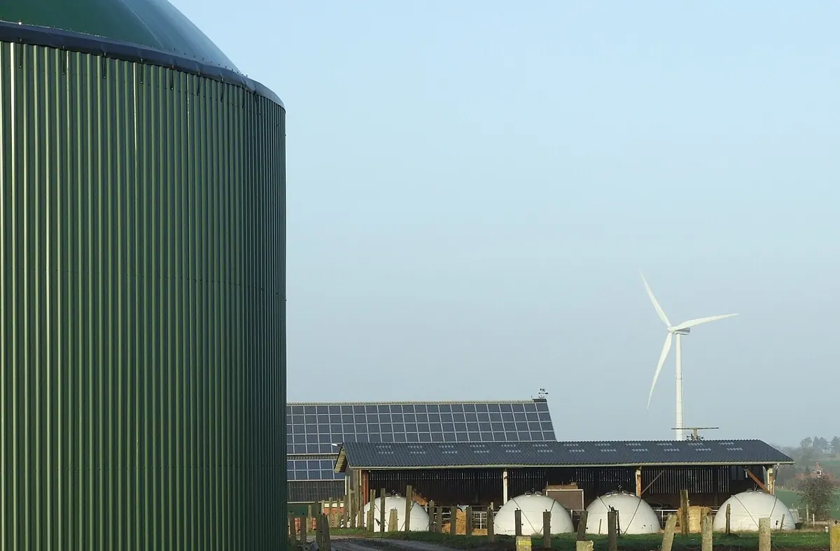 A biogas installation with a large green digester tank.