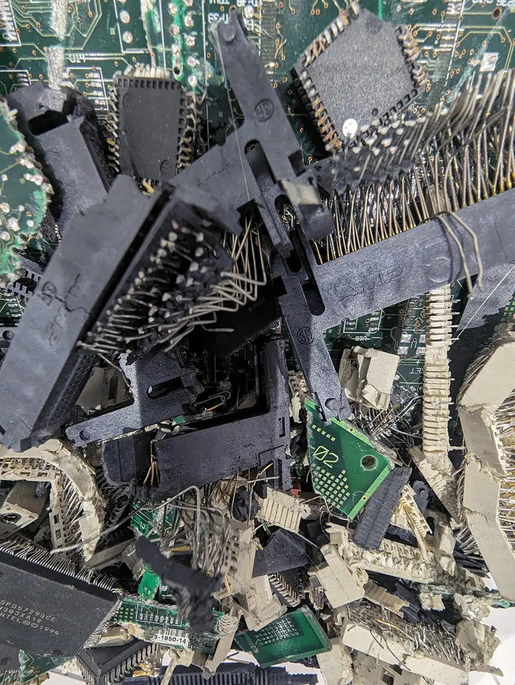 Separated electronic waste and recovered components at a recycling facility.