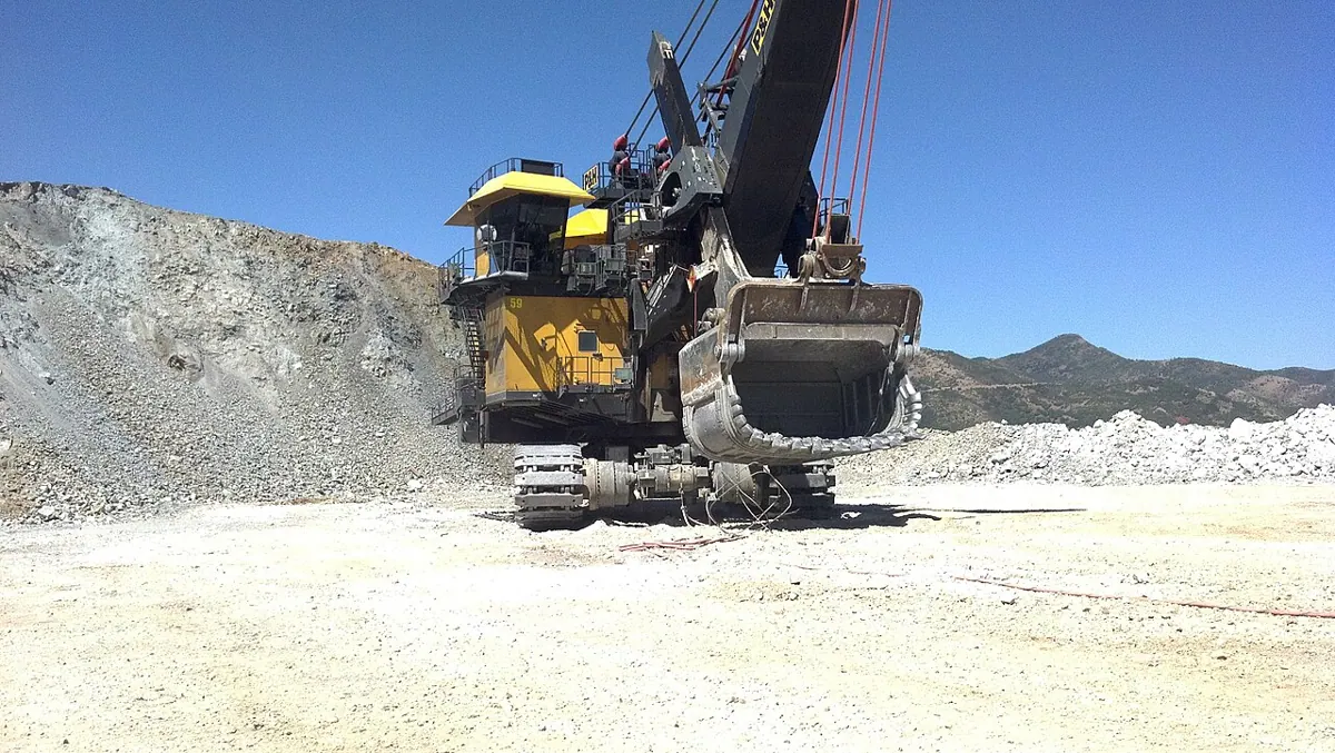 Heavy machinery works in an open-pit copper mine.