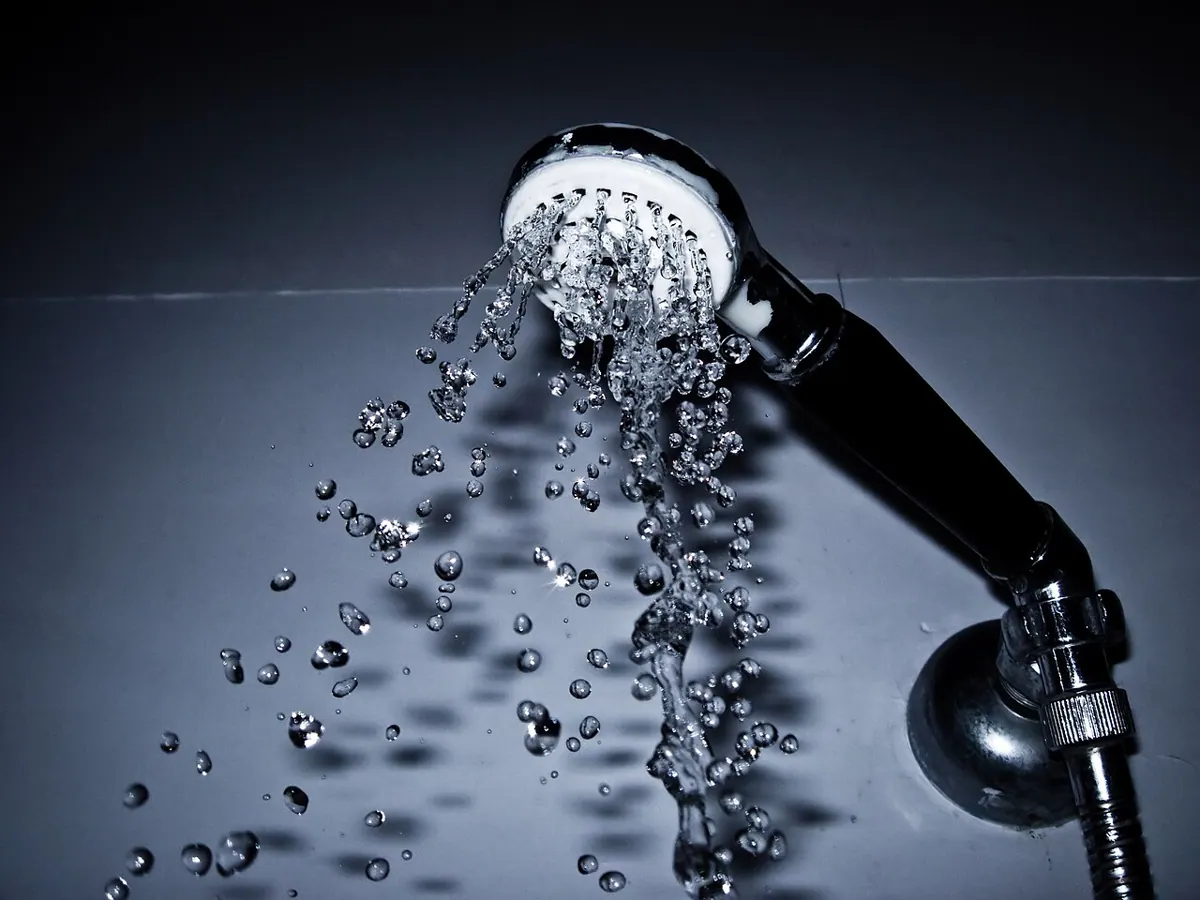 Water streams from a shower head.