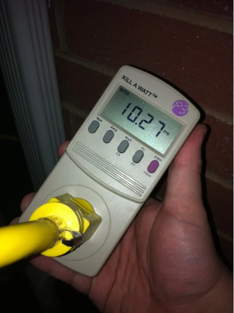 A plug-in electricity meter measures an appliance load.