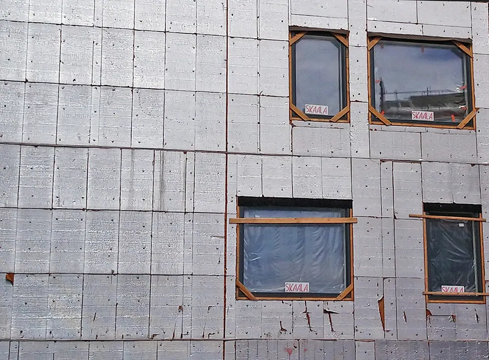 Thermal insulation fitted to the exterior walls of a building under construction.